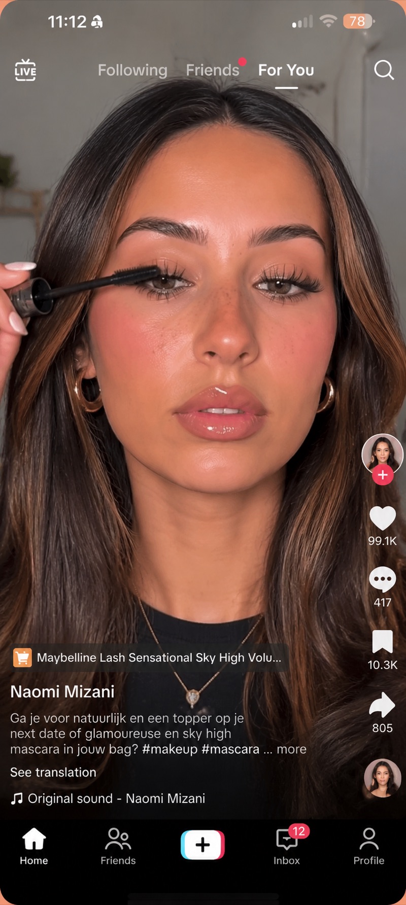 A creator applying Maybelline Lash Sensational Sky High mascara